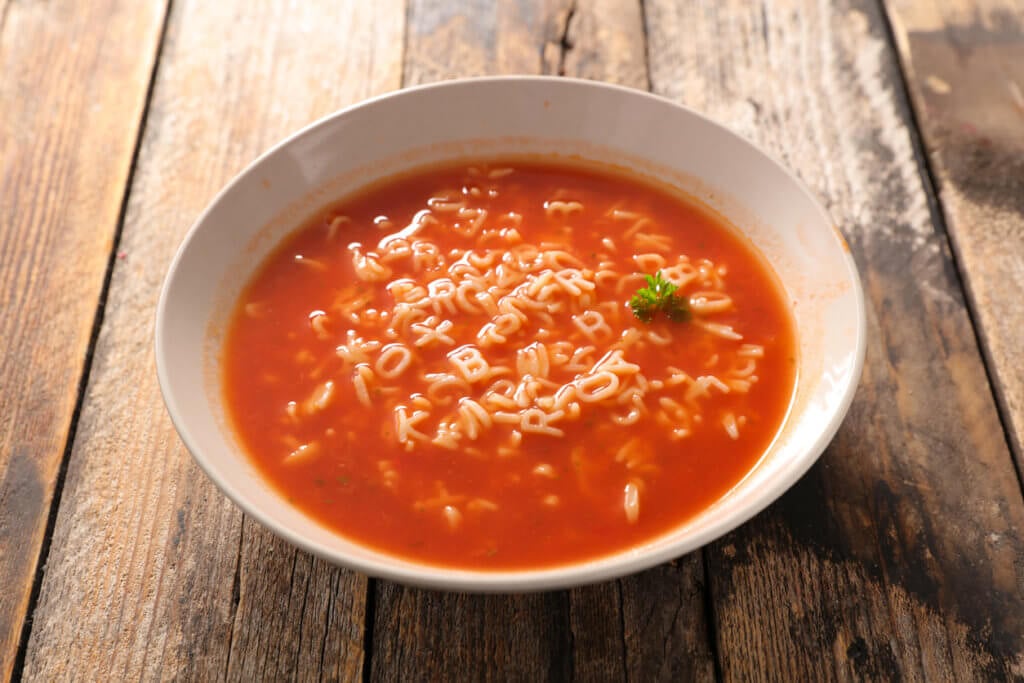 alphabet noodle soup on table.