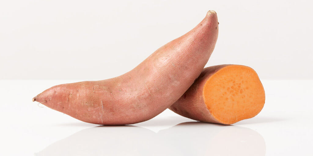 Sweet Potatoes, grocery store produce, on a blank background.