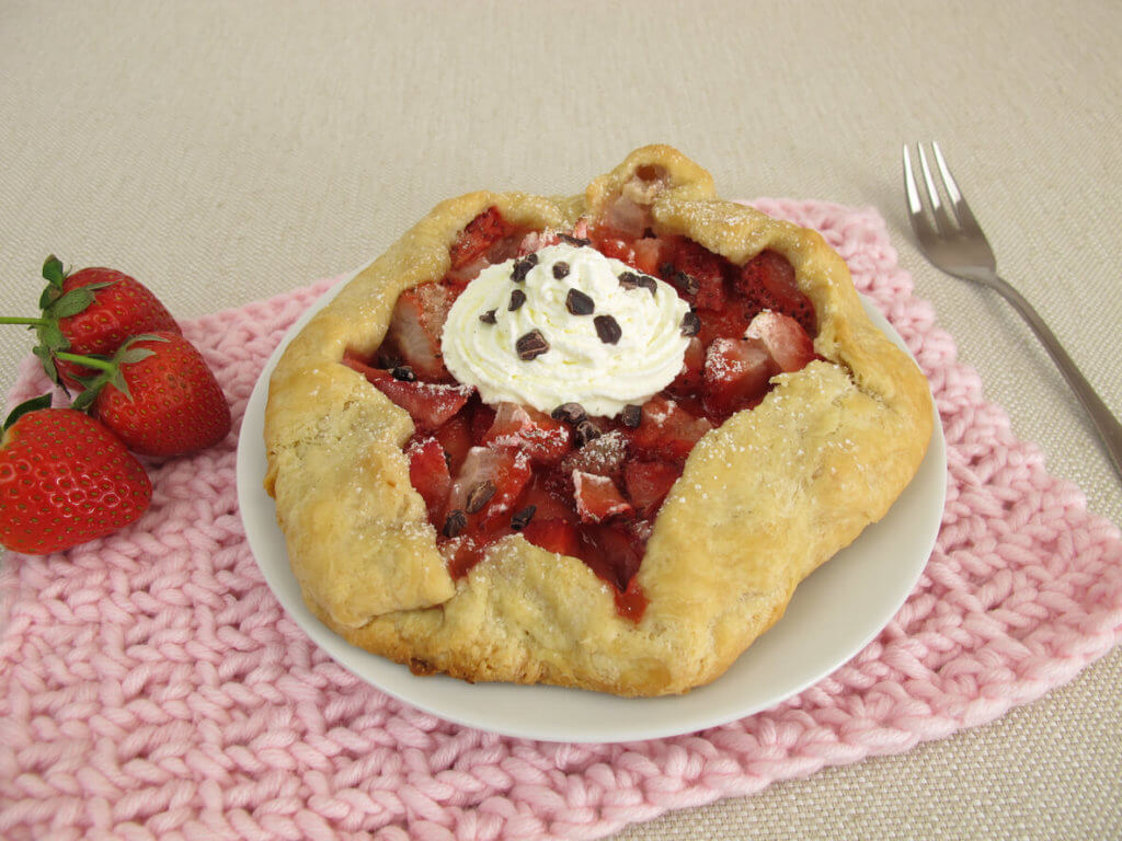 Strawberry galette with whipped cream and cocoa nibs