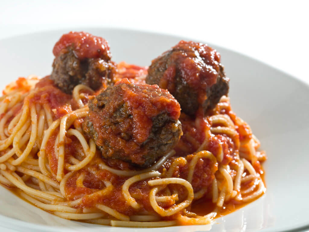 plate of spaghetti with three meatballs