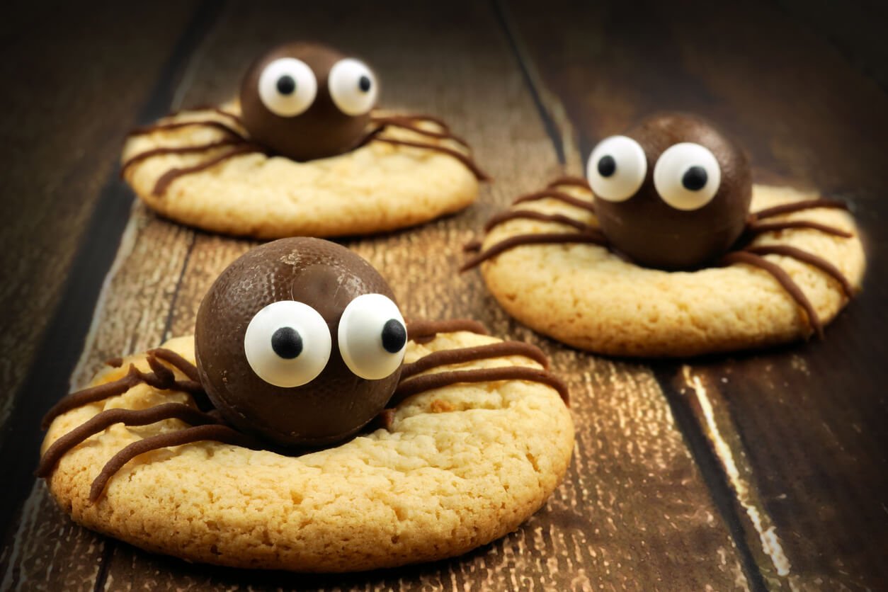 Chocolate Halloween spider cookies on rustic wood