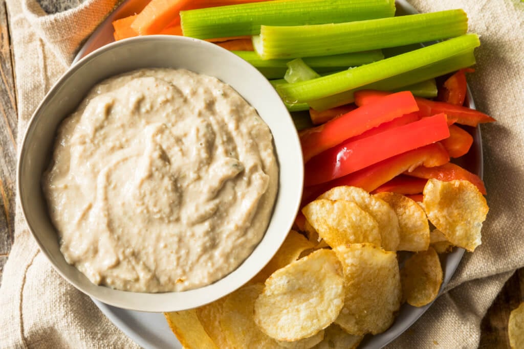 Homemade Carmelized Onion Dip with Chips and Veggies.