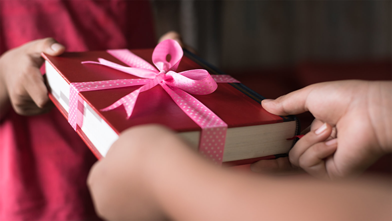 Person receiving a book on Valentine's Day