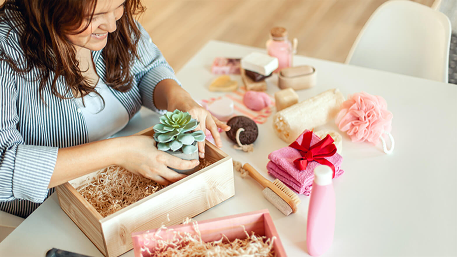 A person building a Valentine's Day gift basket