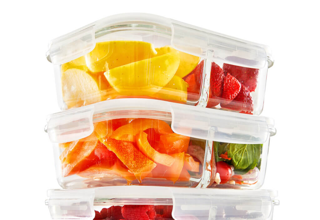 Set of 3.3 Oz Food Storage Containers with 2 Compartment and Vented Lids Filled with Fruits and Vegetables.