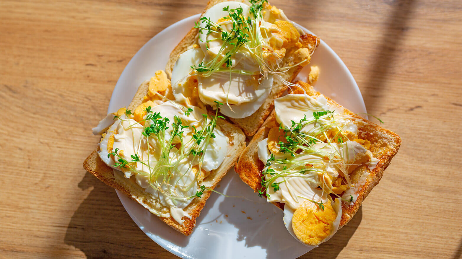 Toast topped with cream cheese, egg and watercress. 