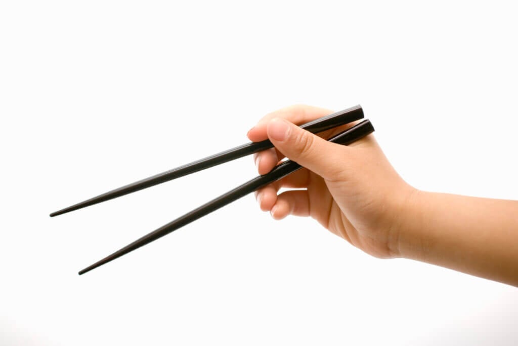 Children's hands using chopsticks