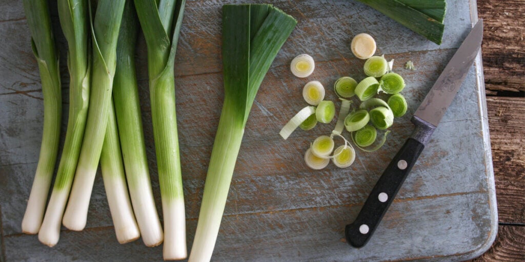 Cutting the bottoms of leeks.