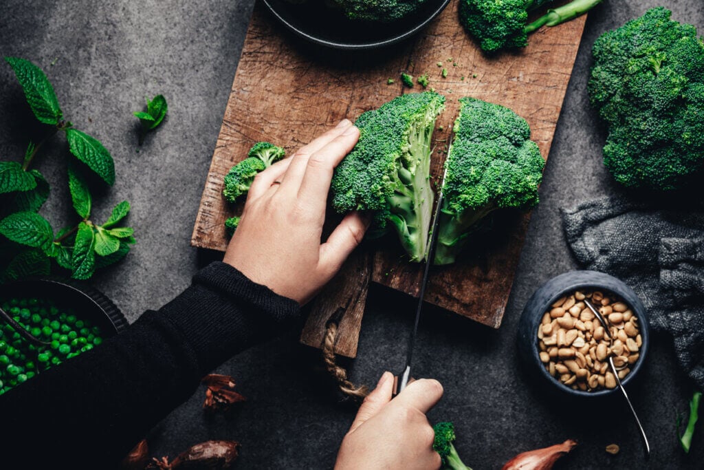 Woman cutting fresh broccoli