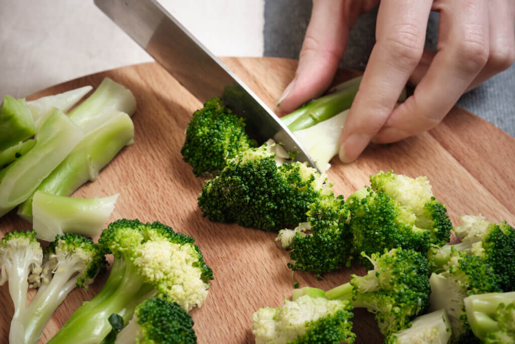 Cutting fresh broccoli with a knife