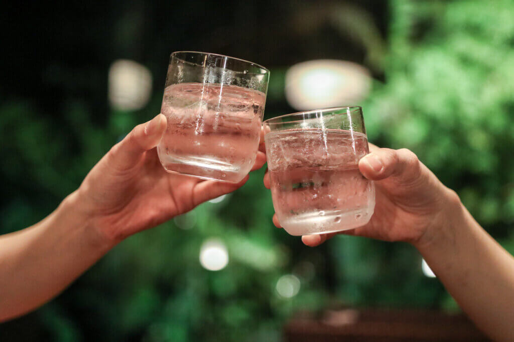 Two people enjoy shochu.