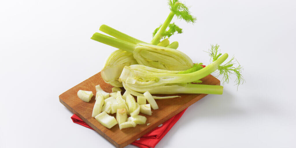 Cut pieces of fennel on a cutting board.