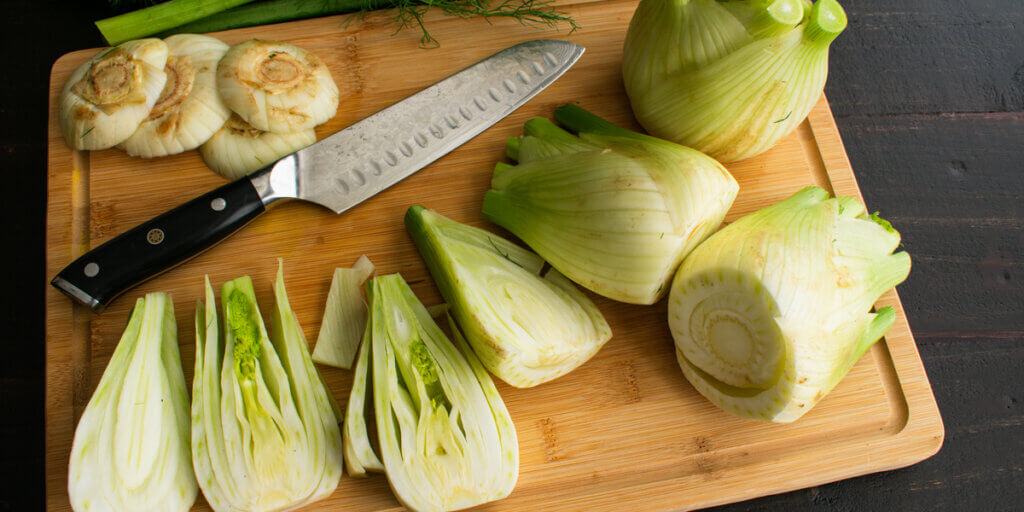 Halved fennel on a chopping board.