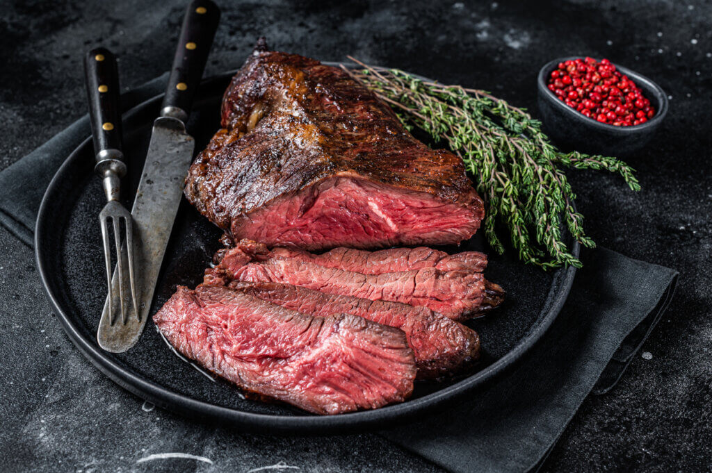 Steak on a plate with thyme.