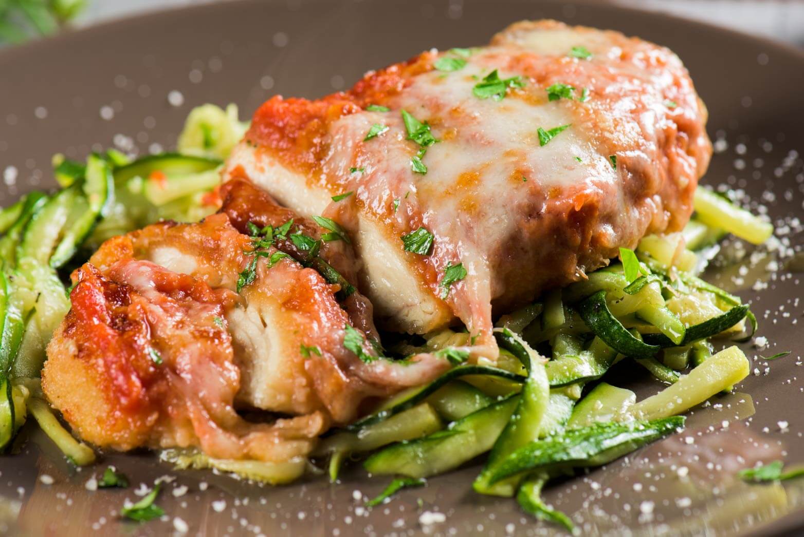 A close up of a delicious looking garlic parmesan chicken with veggies