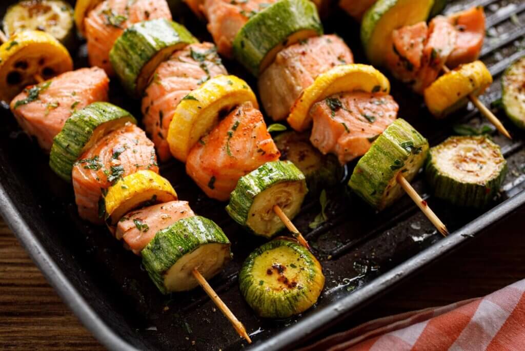 Close up four salmon and zucchini skewers 