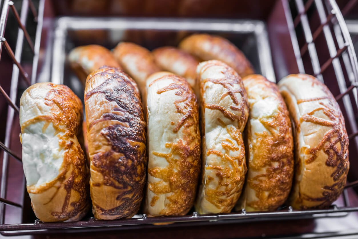 Basket of baked cheese bagels in bakery