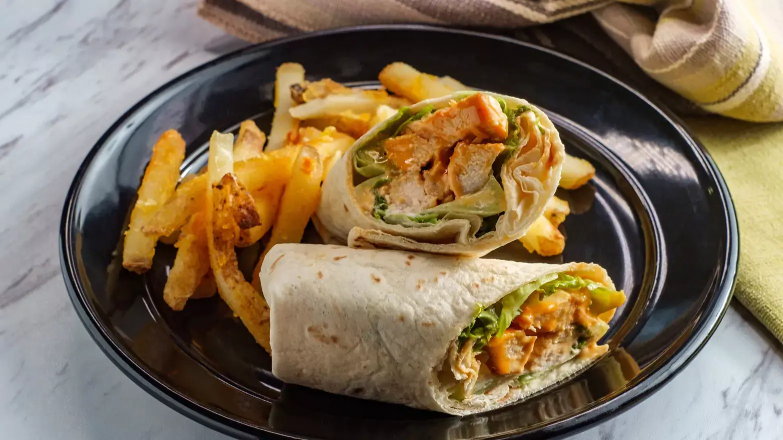 Buffalo chicken wraps with side of french fries