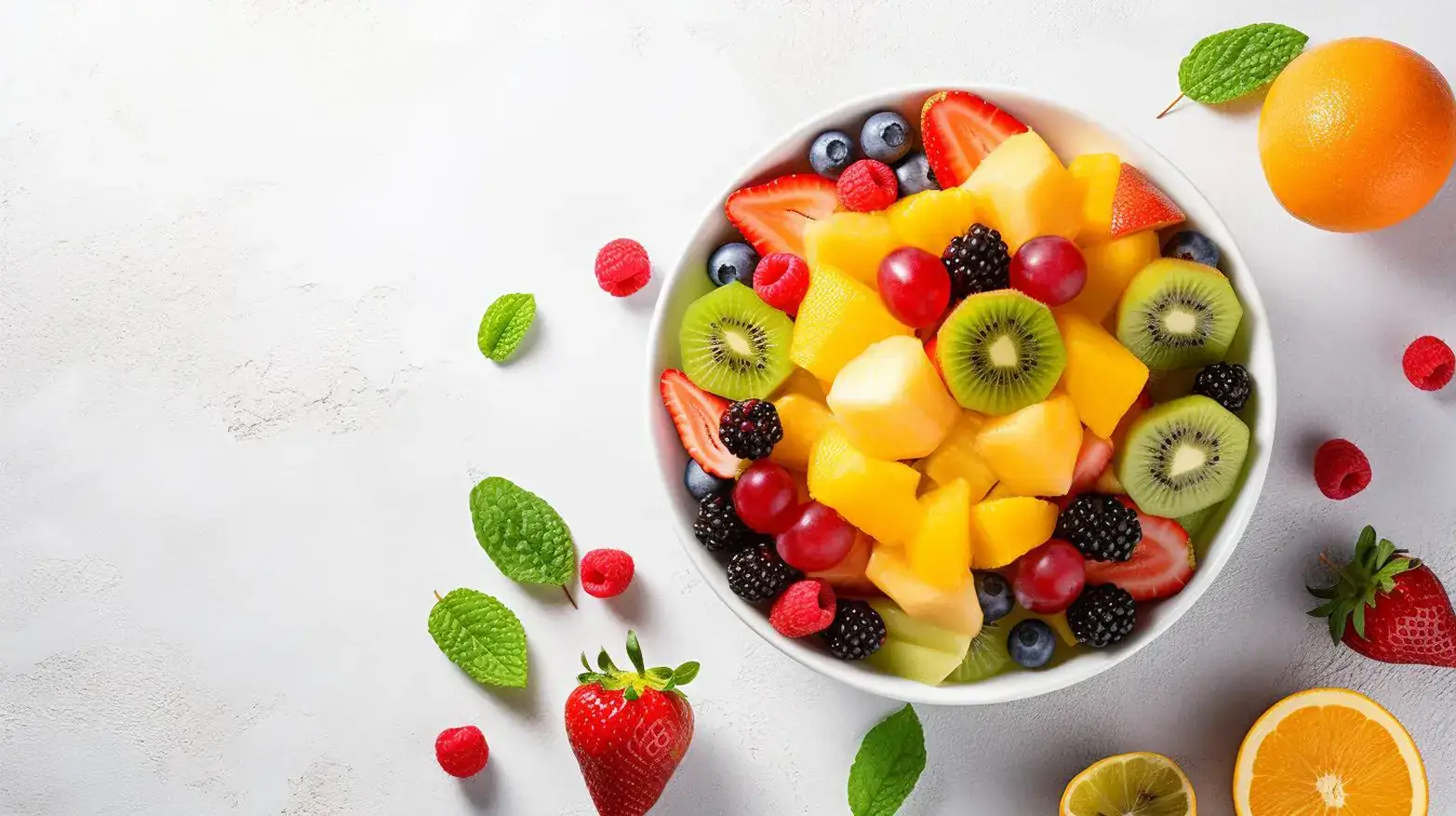 rainbow fruit salad in large white bowl