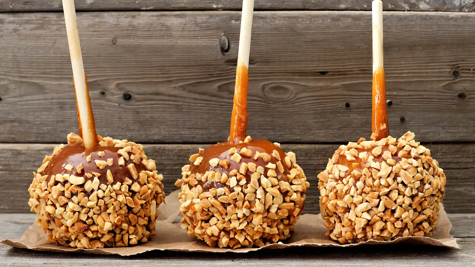 caramel apples coated with crushed nuts.