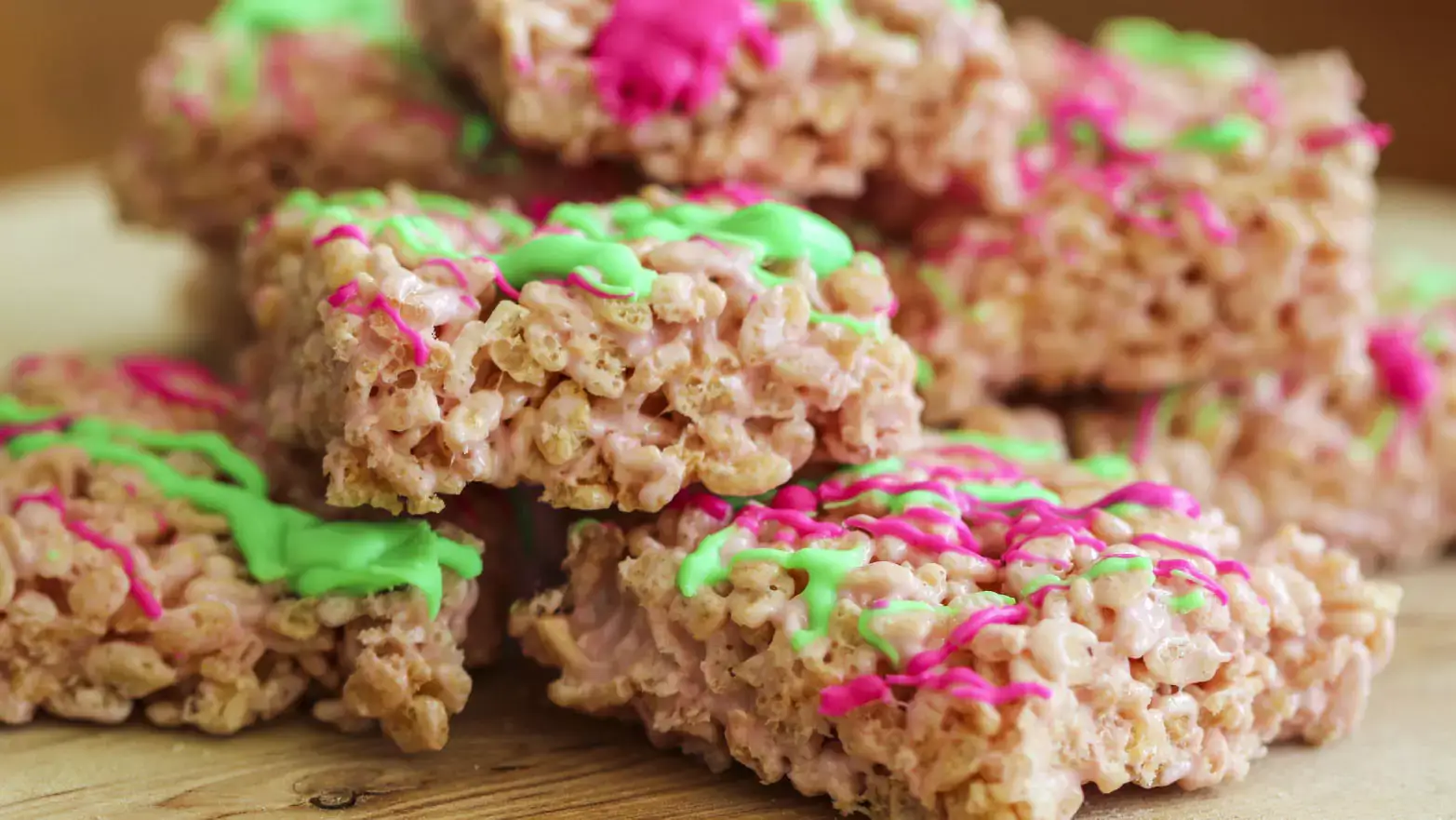 Rice Krispie treats drizzled with pink and green icing