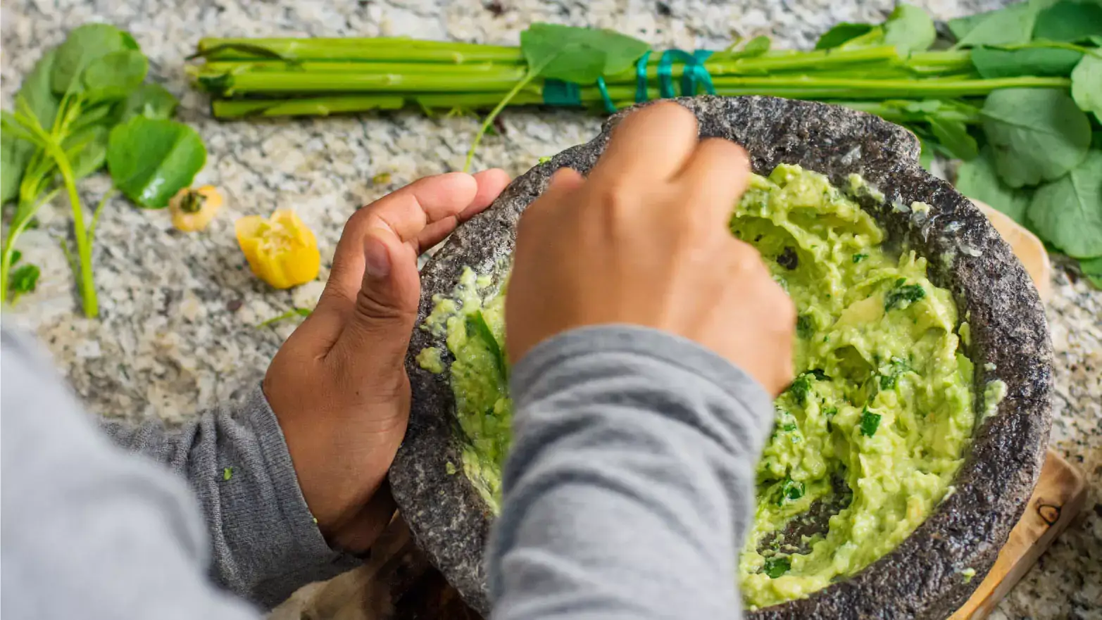 Child mashing avocado in bowl