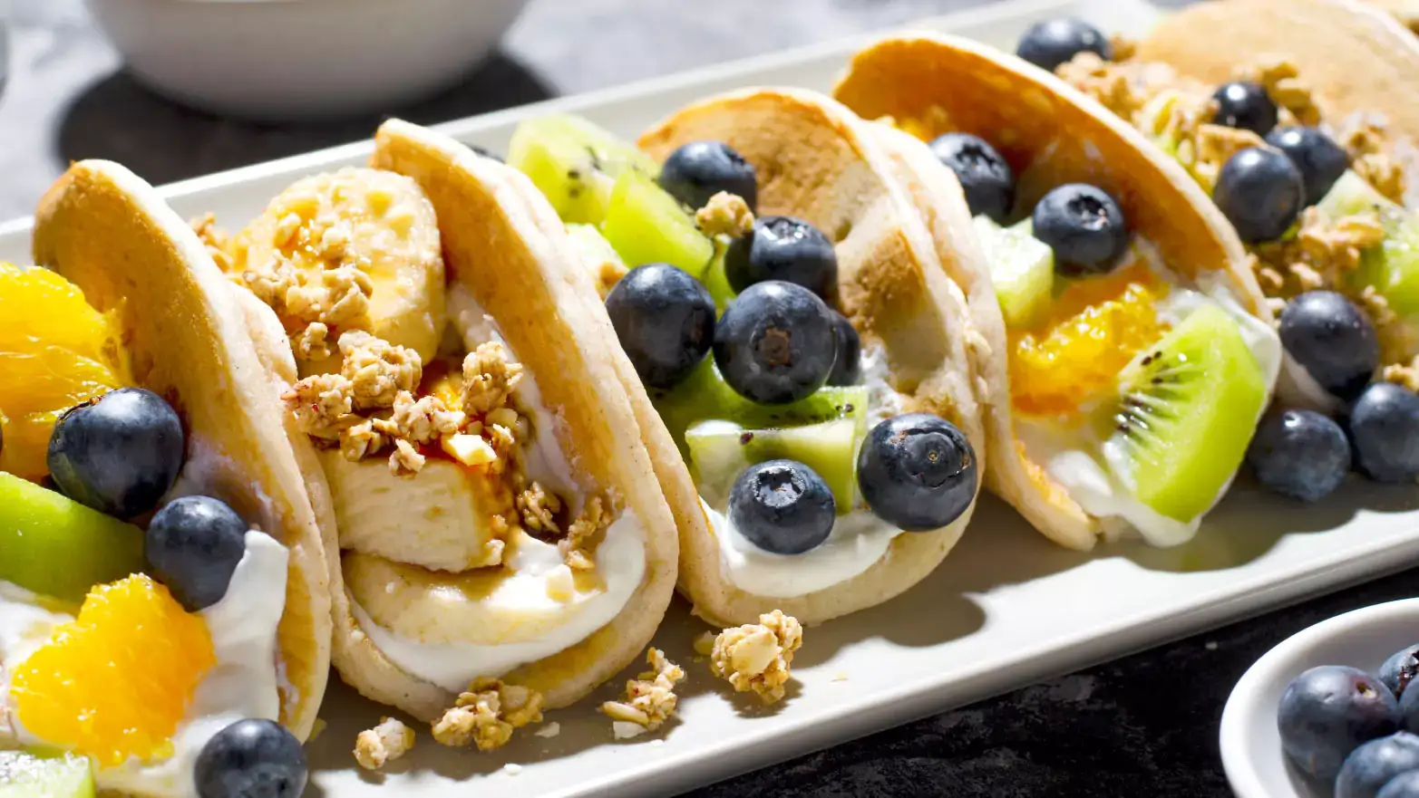 Taco pancakes filled with yogurt and fresh fruit 