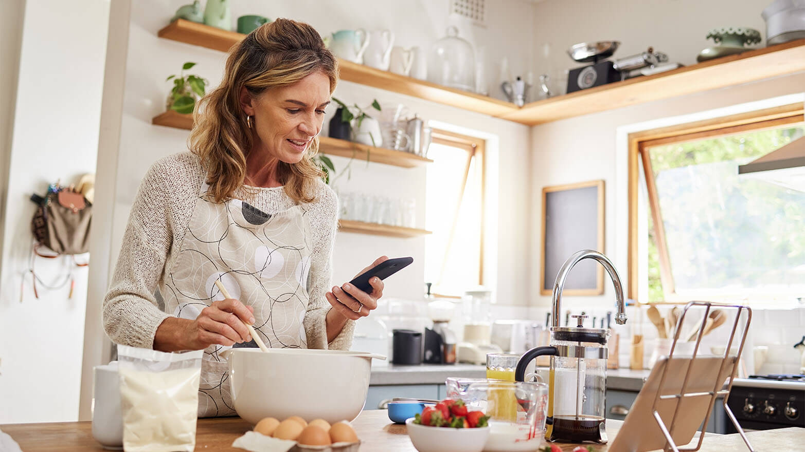 Person baking and using a cake calculator.