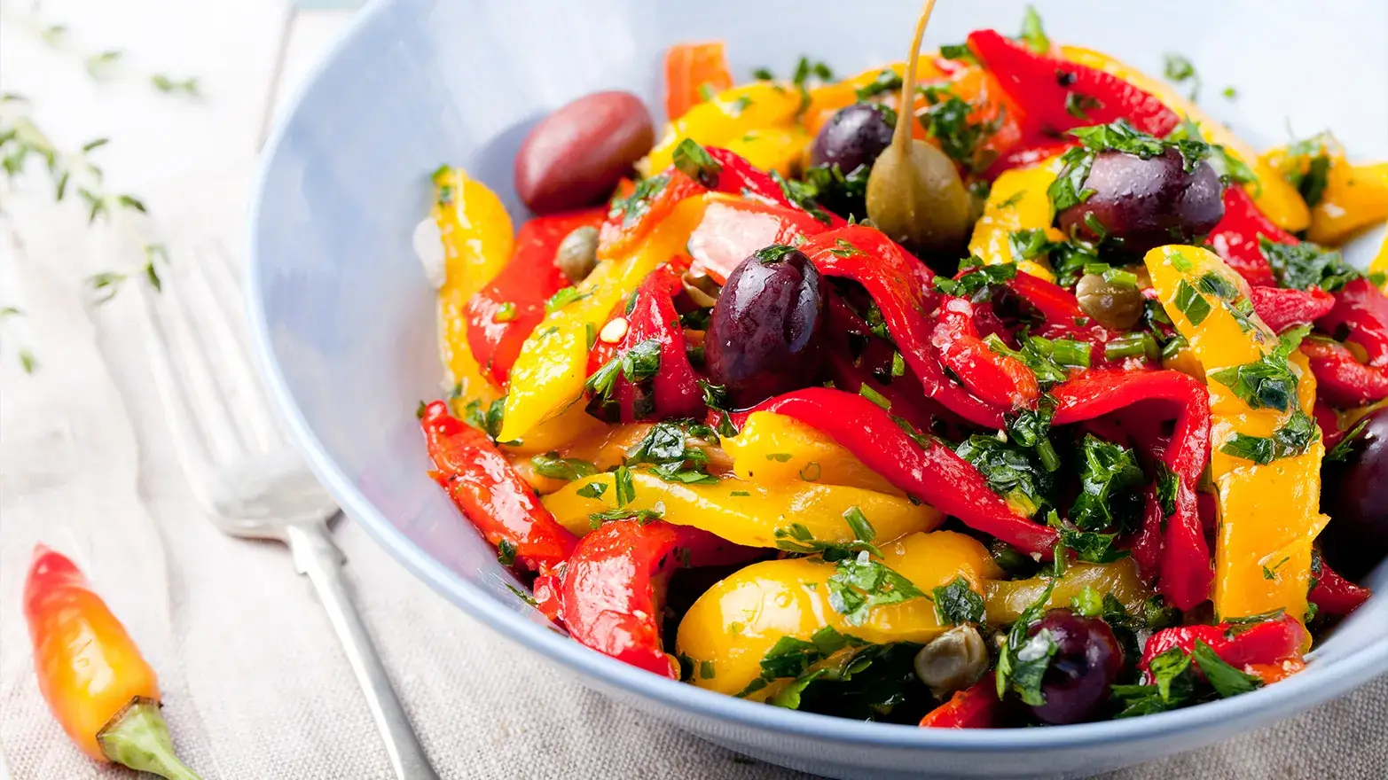 Roasted yellow and red bell pepper salad with olives and cilantro.