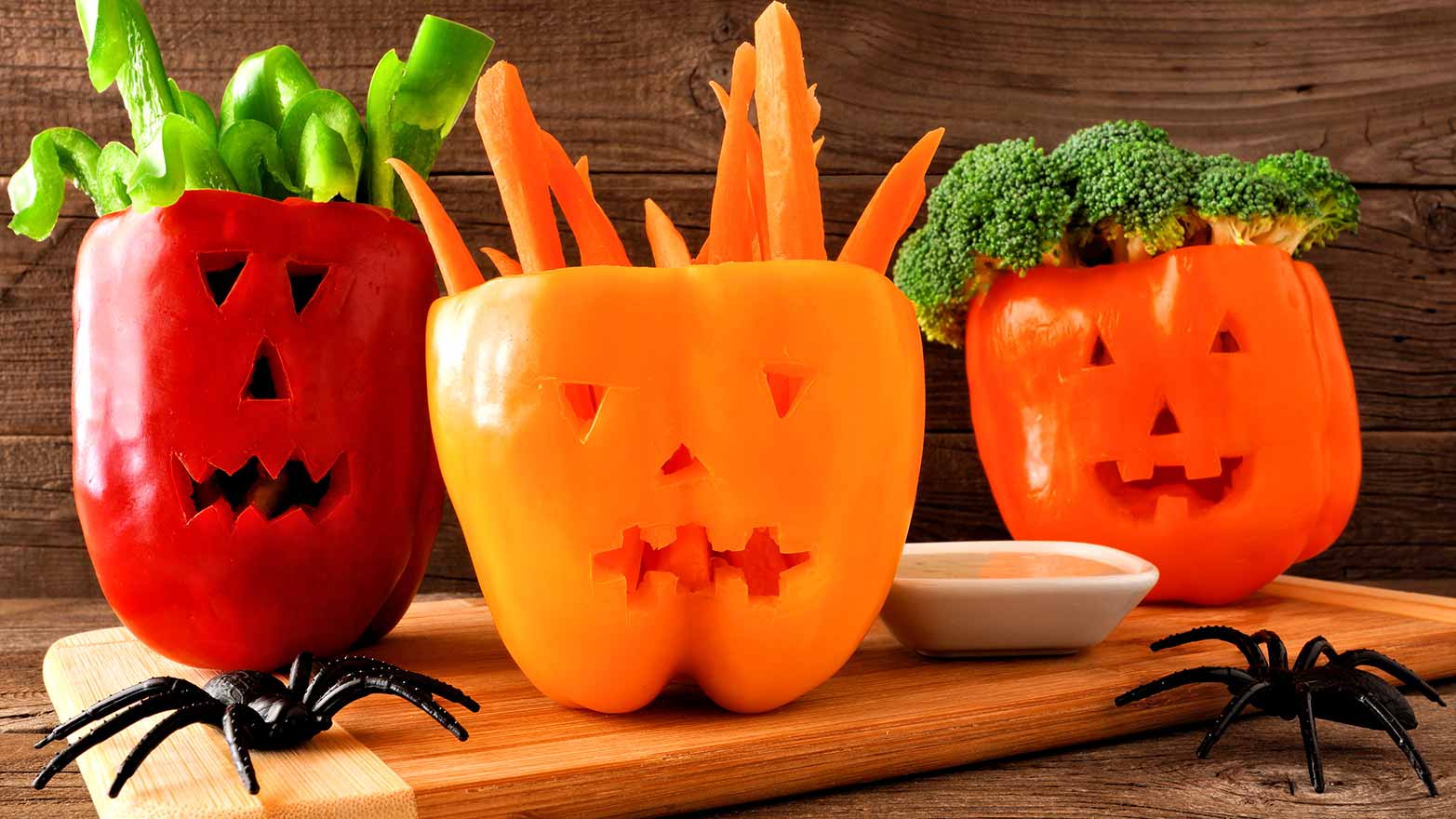 Bell peppers with carved pumpkin faces