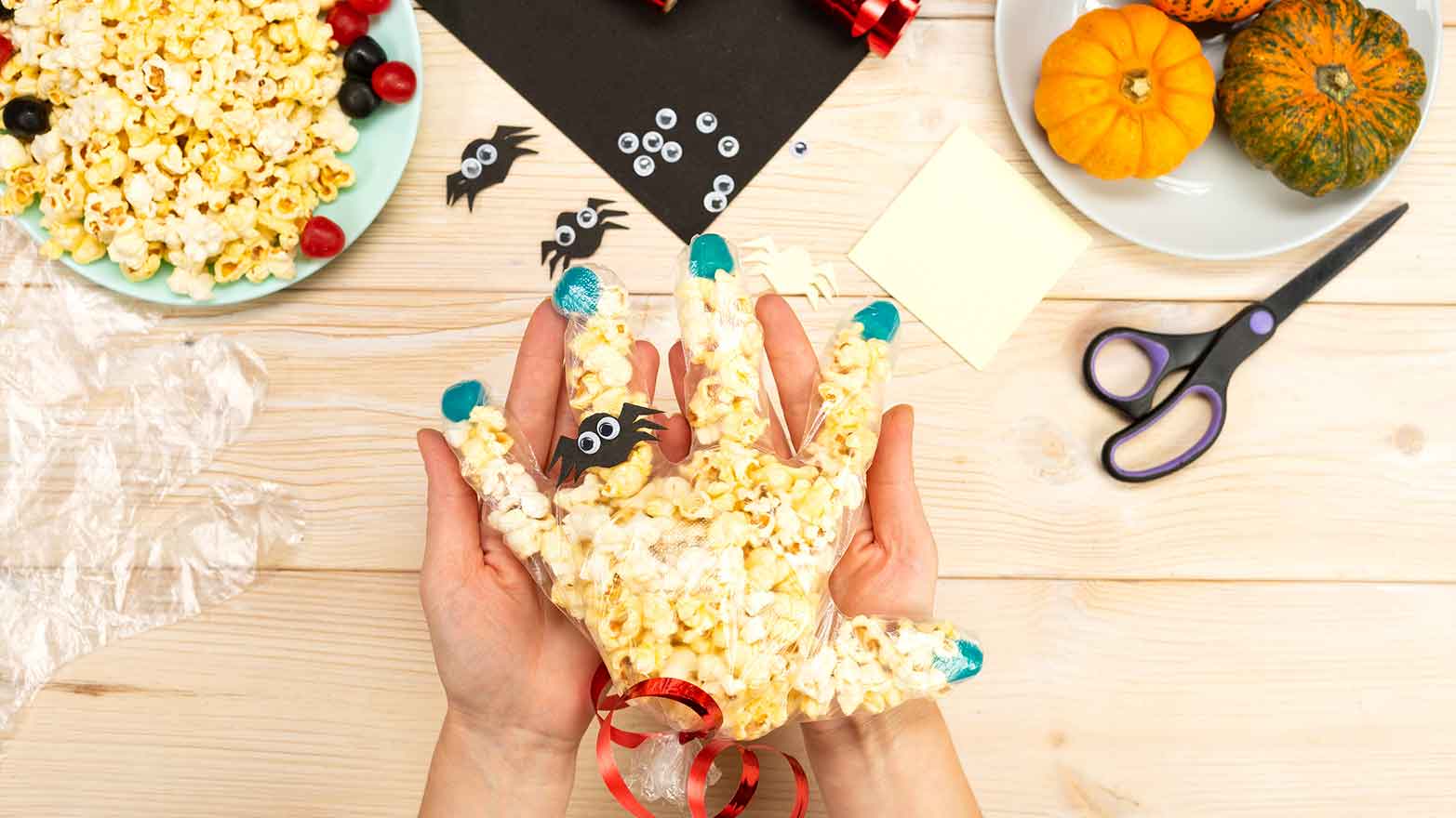 Halloween hands filled with popcorn