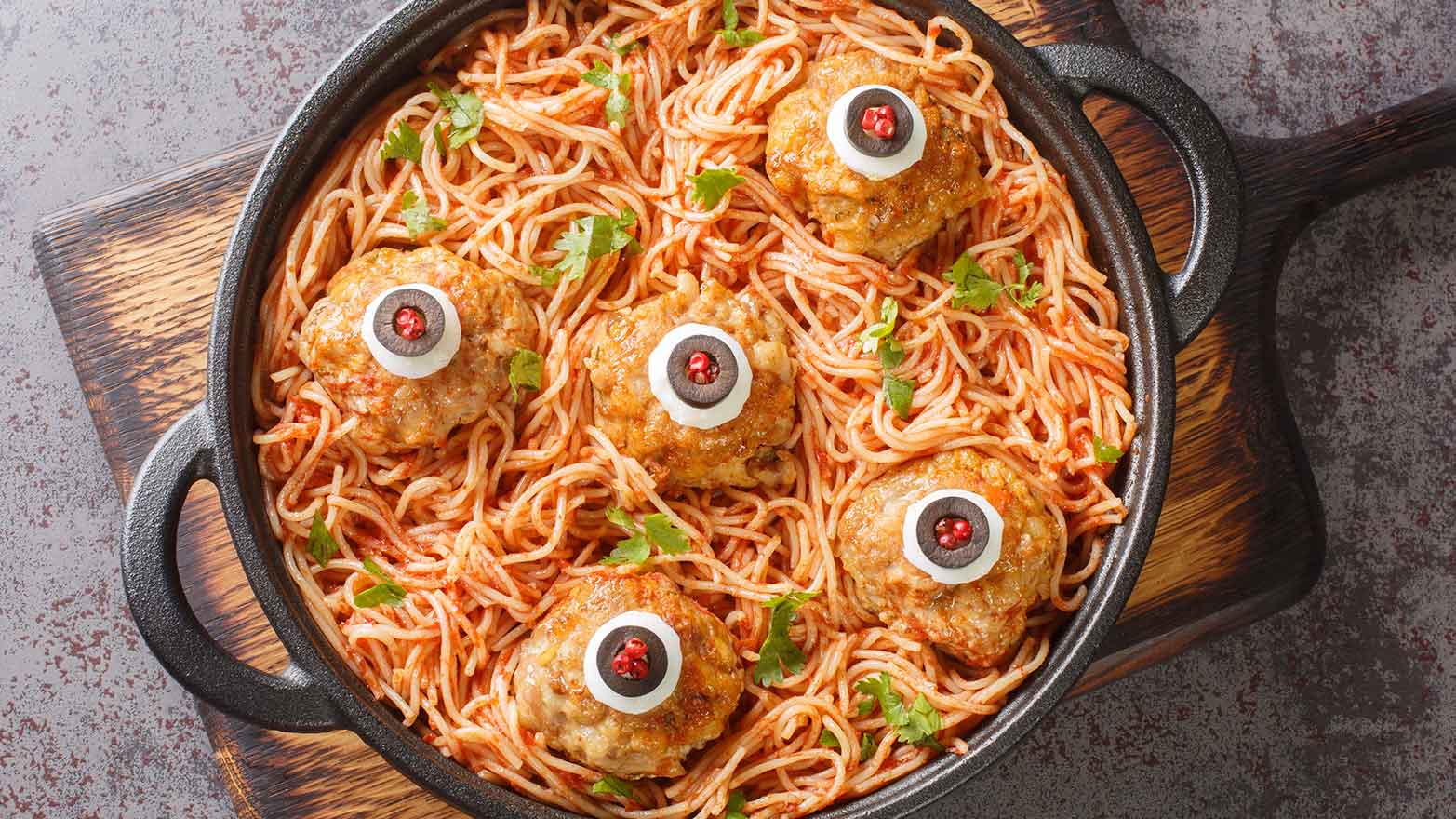 Meatballs with mozzarella and stuffed olive eyes and spaghetti