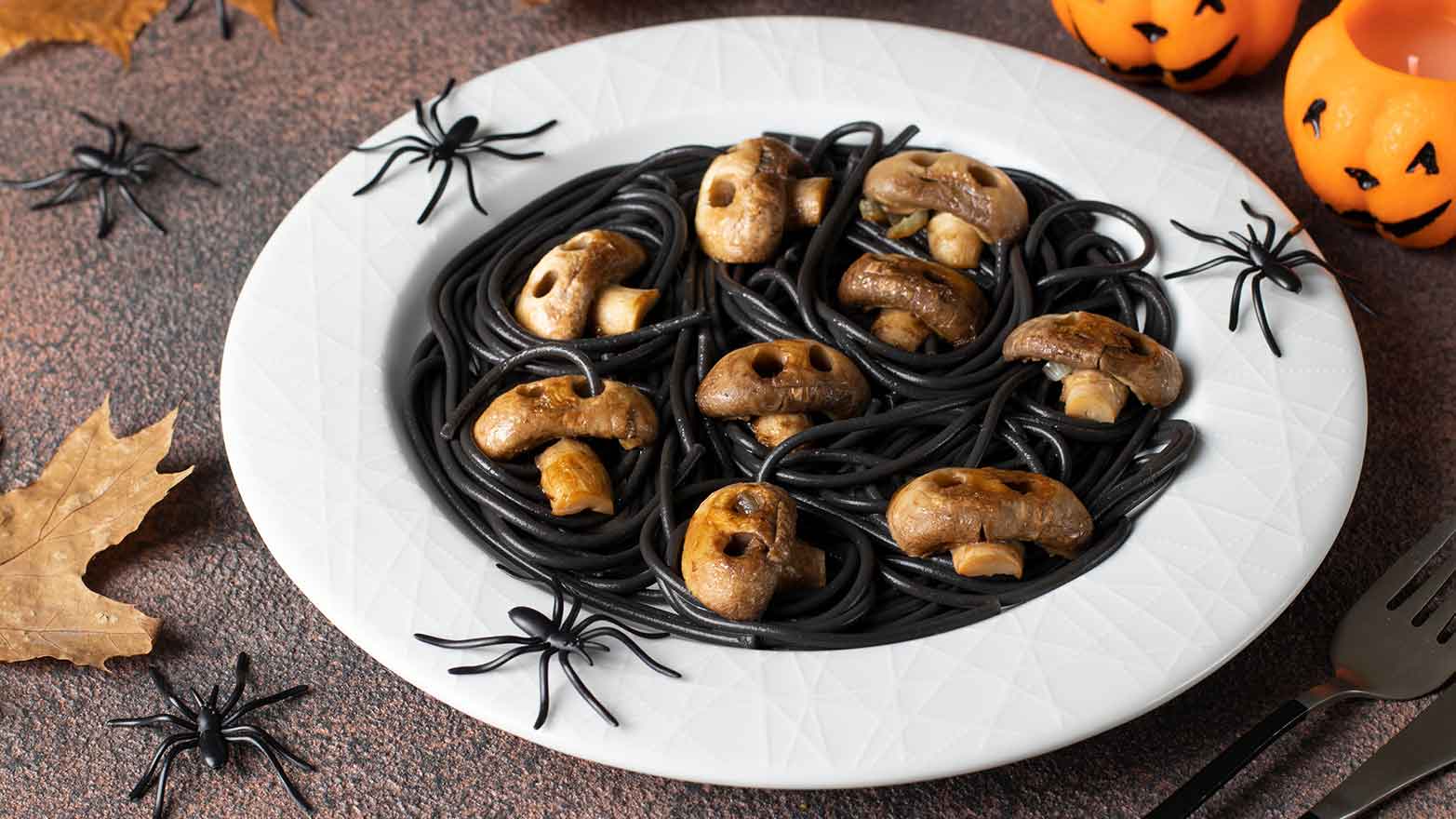 Black spaghetti with mushrooms shaped like skulls