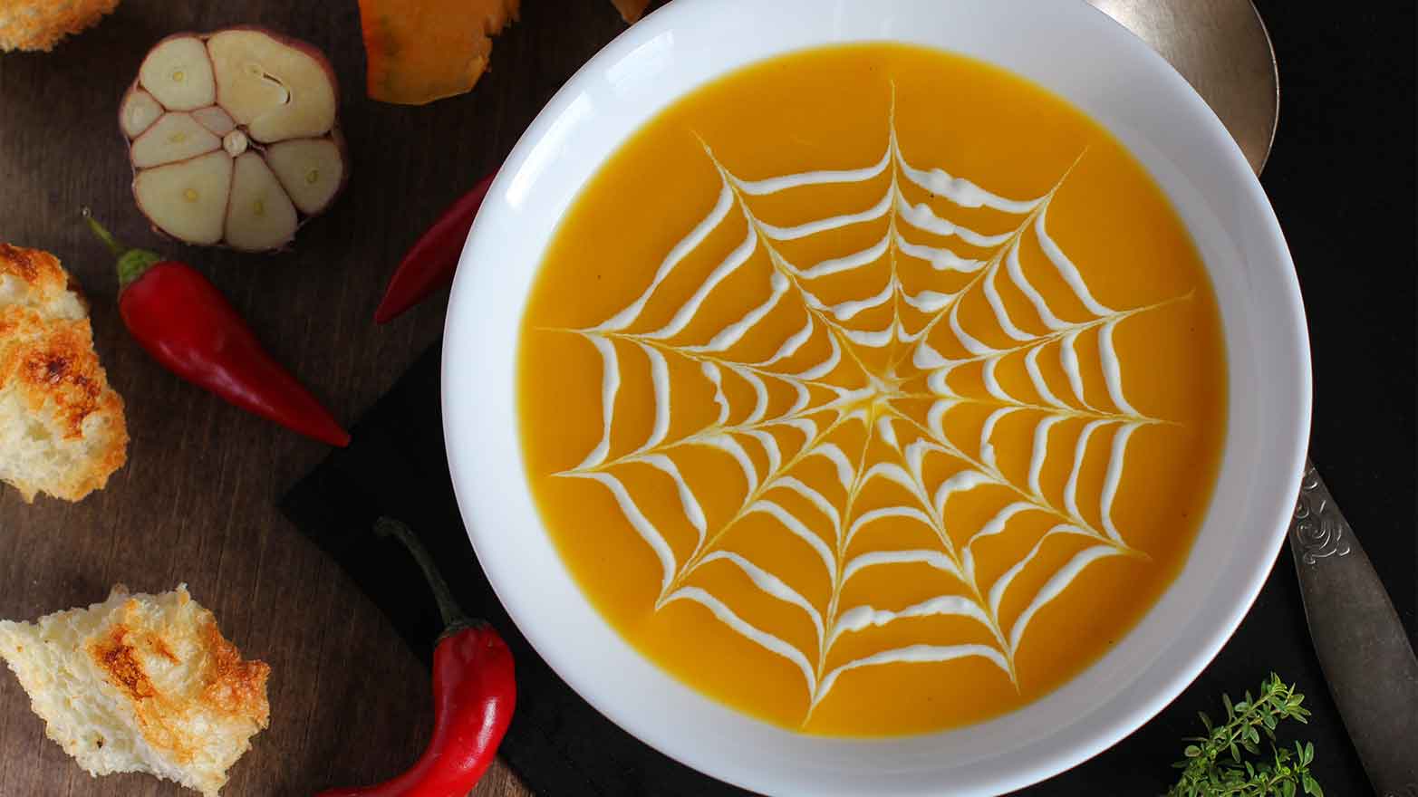 pumpkin soup with spiderweb design