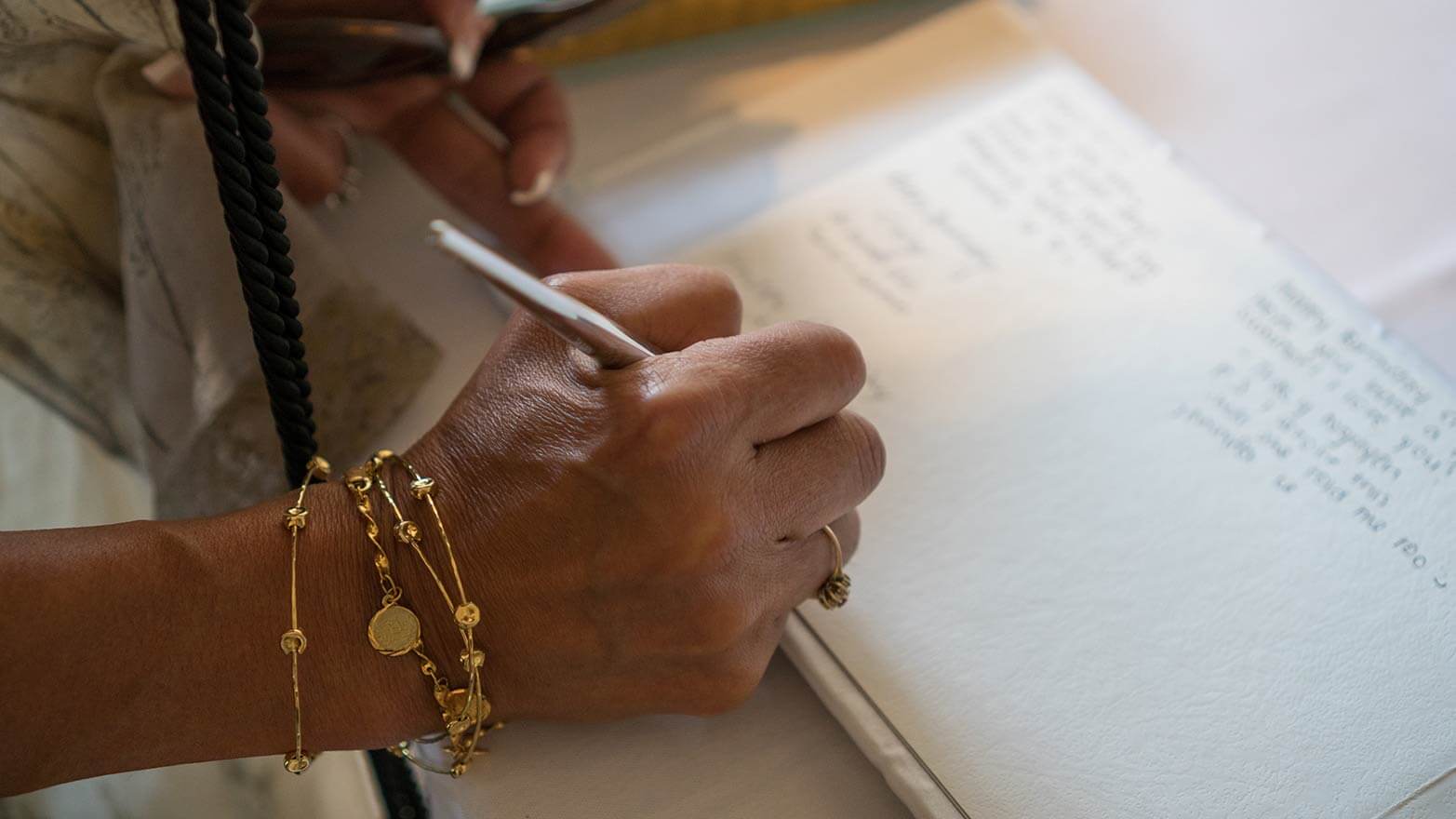 A person signing a memorial guest book