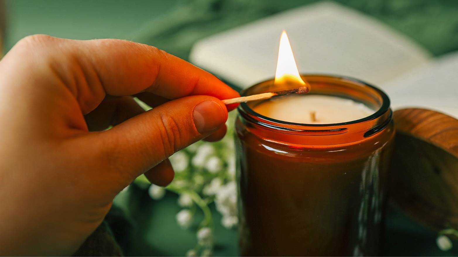 A person lighting a memorial candle