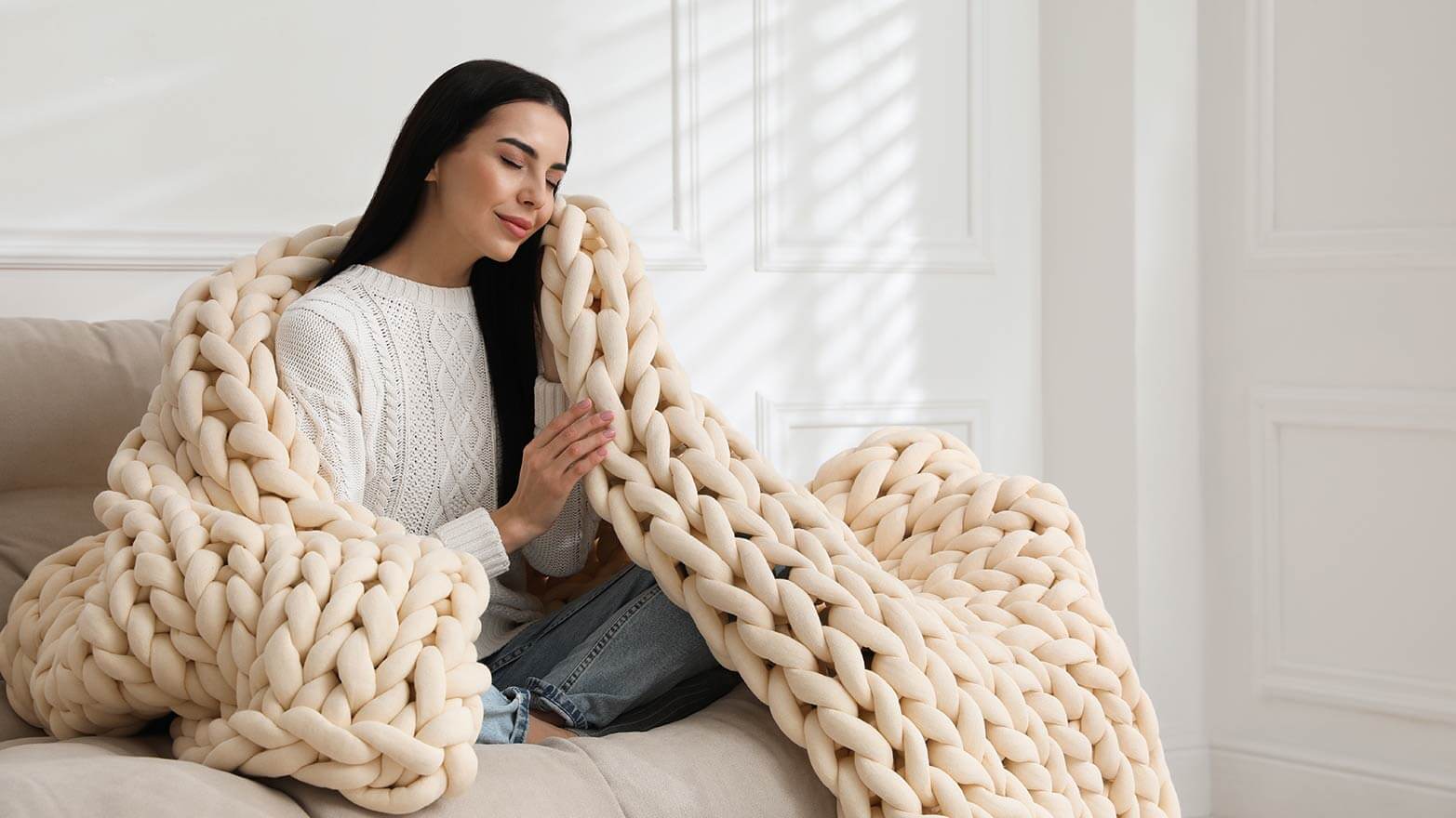 A person cuddling with a weighted blanket