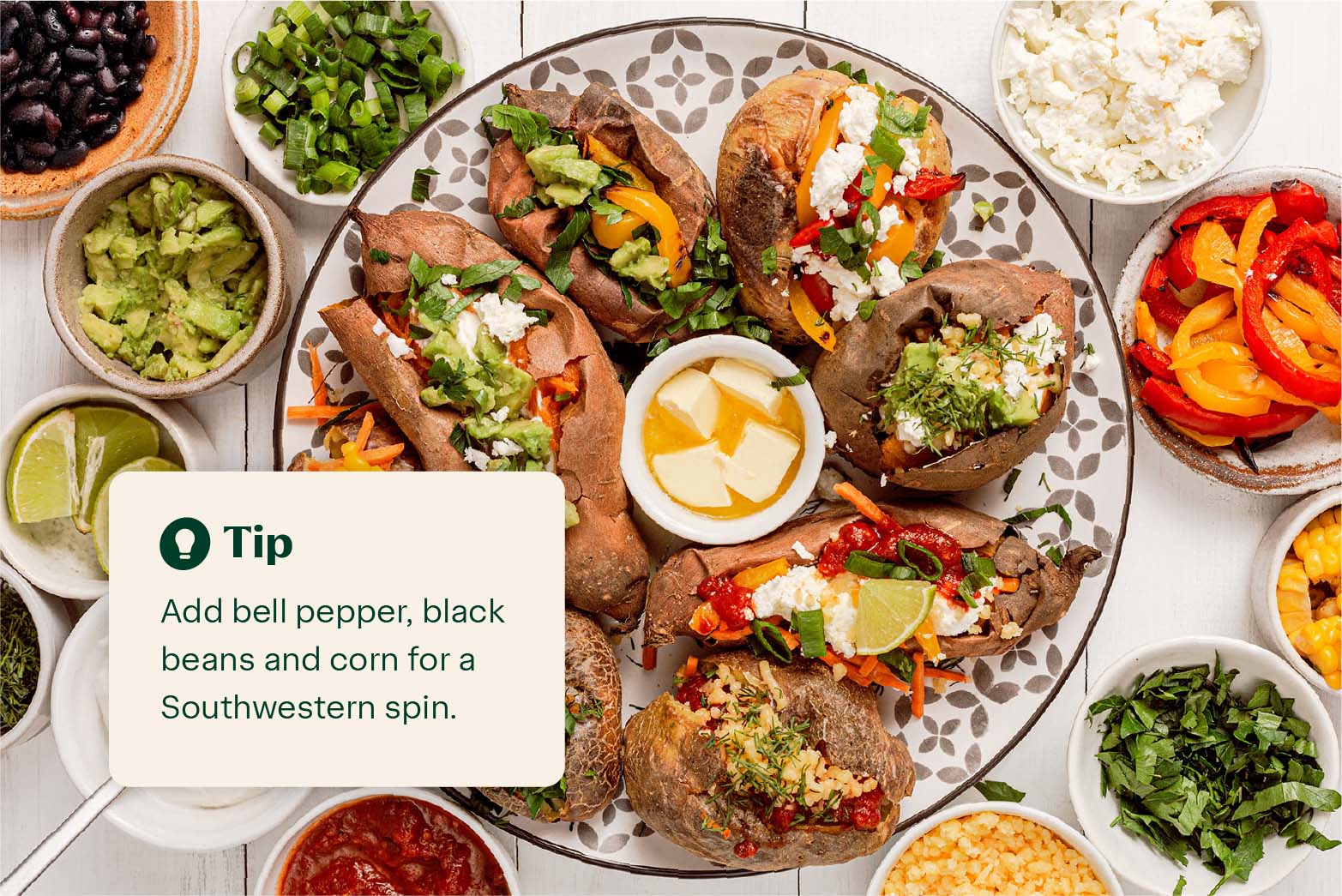 Baked sweet potatoes on a plate with a variety of toppings