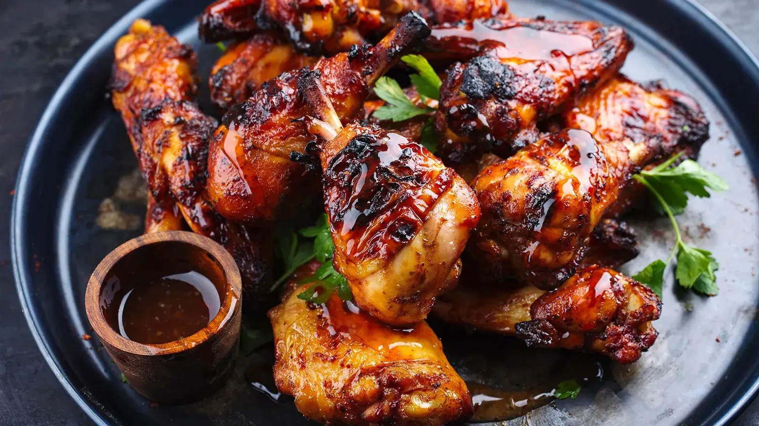 Plate of jerk chicken topped with herbs