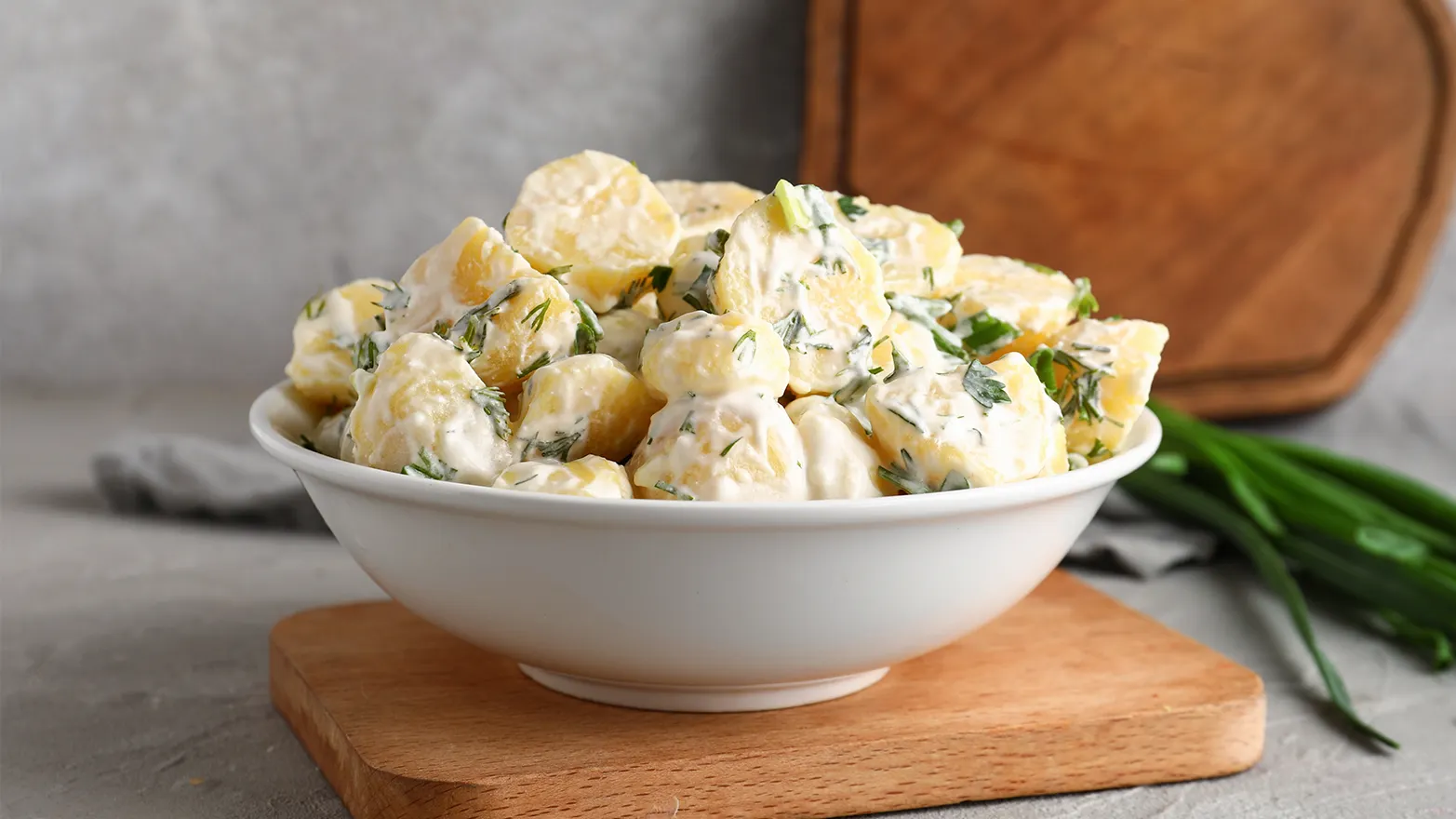 Large white bowl of potato salad, which is the perfect super bowl recipe