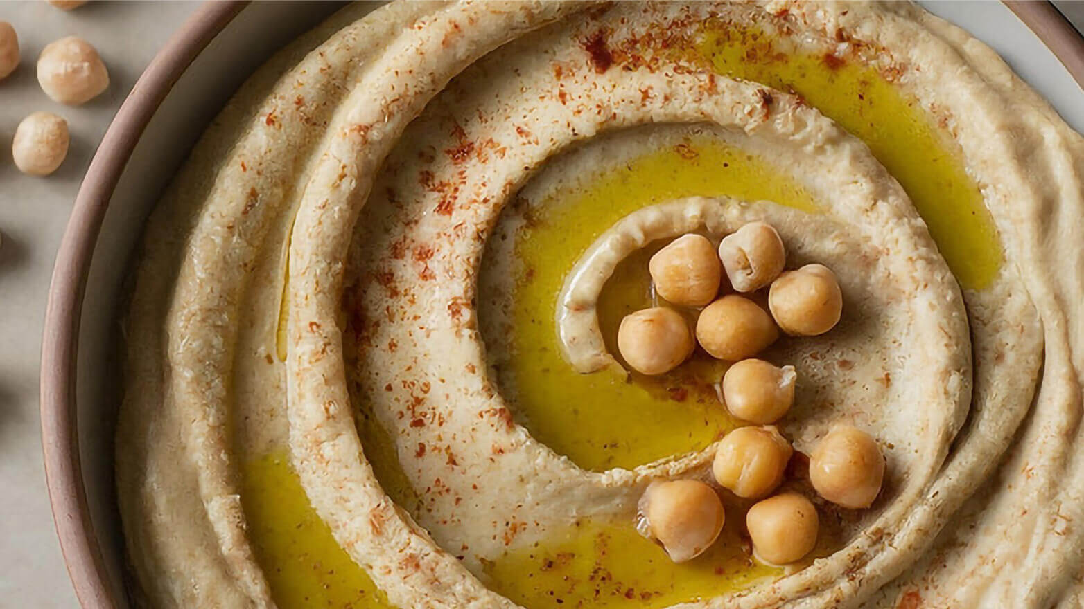 Freshly made hummus topped with chickpeas and paprika