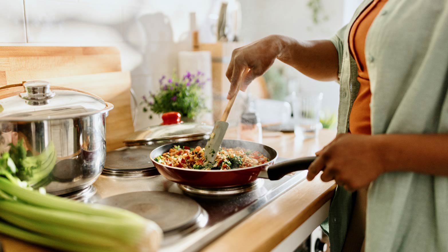 A person cooking a beginner-friendly recipe on a stovetop.