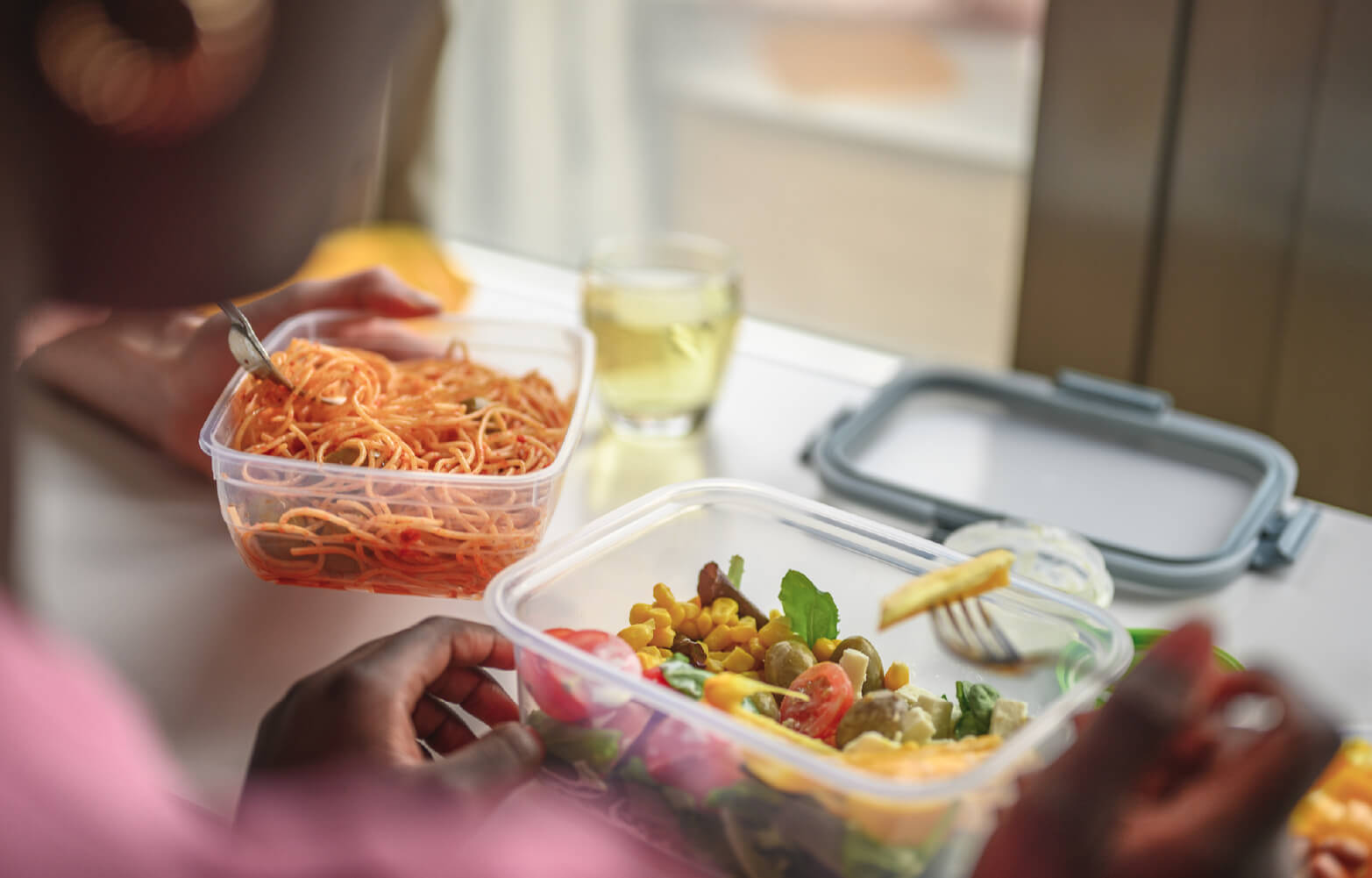 A person saving their leftovers into portion-control containers